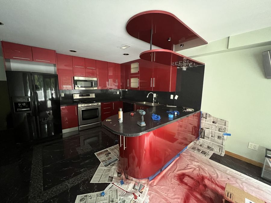 High-Gloss Kitchen - Curved peninsula and full-height cabinets, floor covered while we work - Sani Building Corp