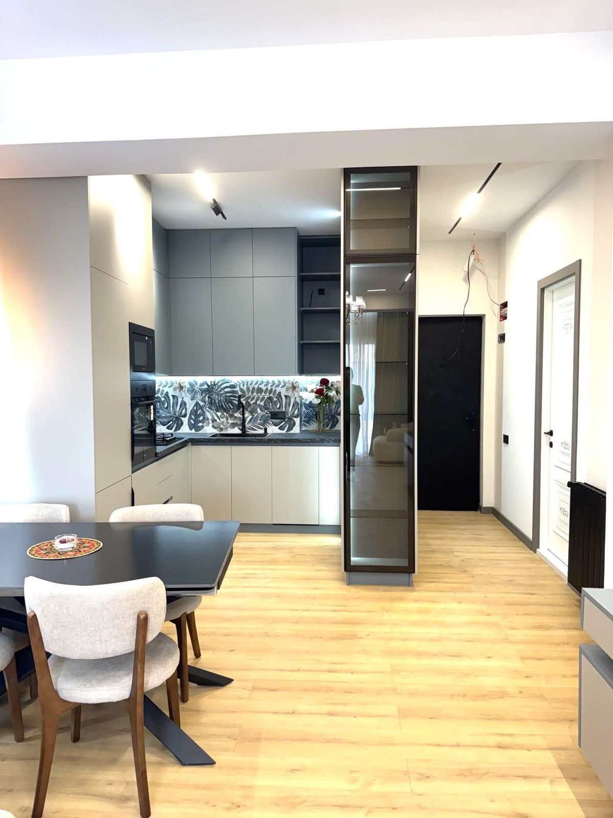 Finished kitchen with a glass display cabinet and panels